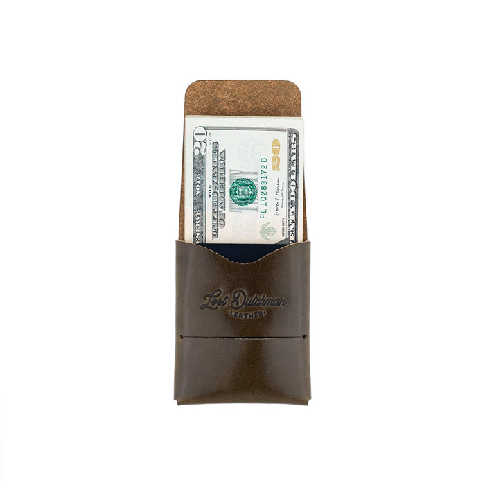 Brown leather money clip with dollar bill on a white background