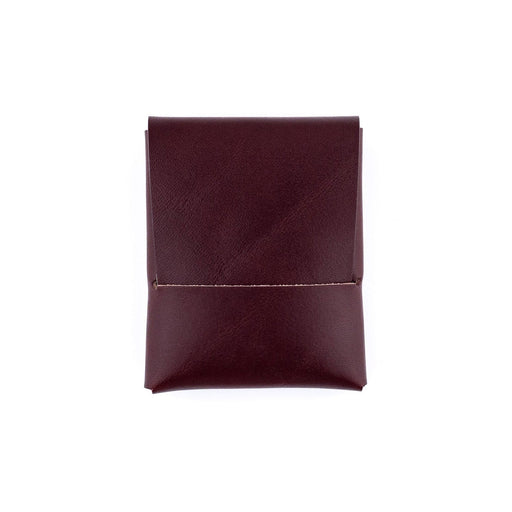 Folded maroon fabric on a white background