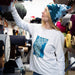 Woman wearing a white sweatshirt with blue pattern in a fabric store
