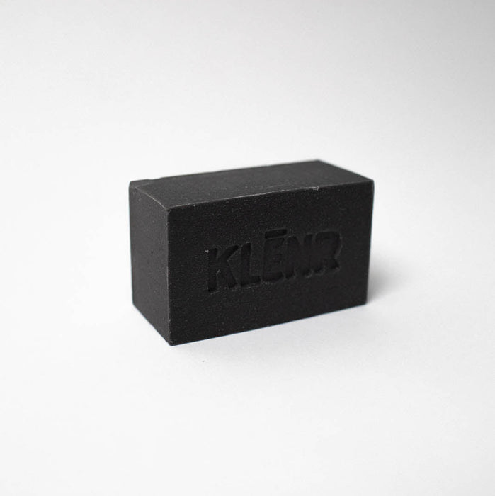 Black rectangular bar of soap with 'KLEEN' branding on a white background