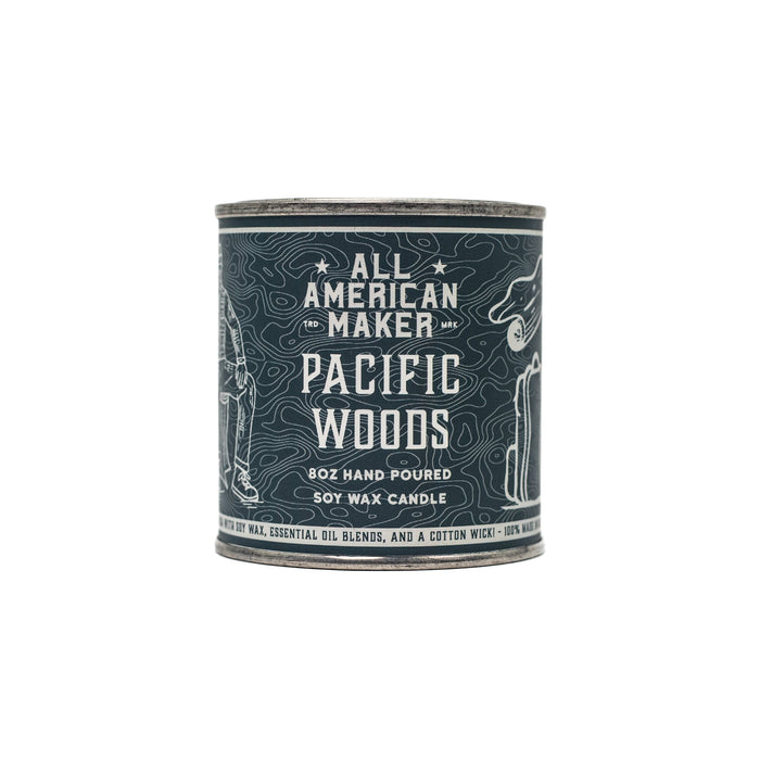 Candle container labeled 'All American Maker Pacific Woods' on a white background