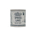 Candle container labeled 'All American Maker Spruce Lake' on a white background