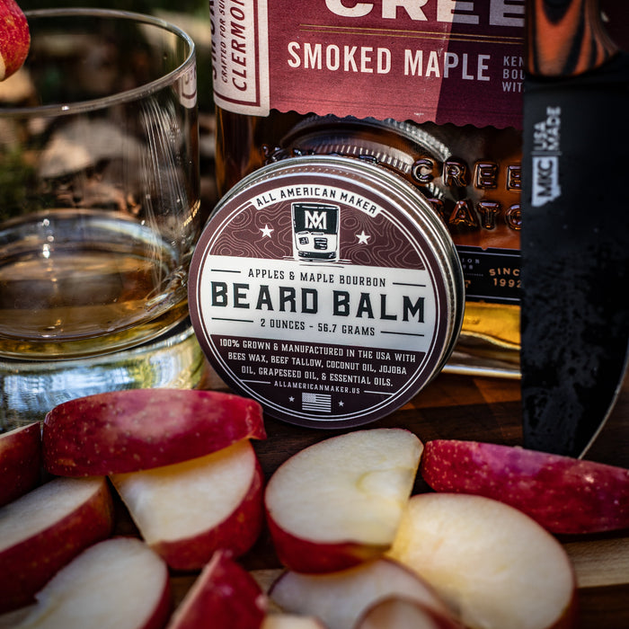 Beard balm container with sliced apples and a bottle of Knob Creek bourbon.