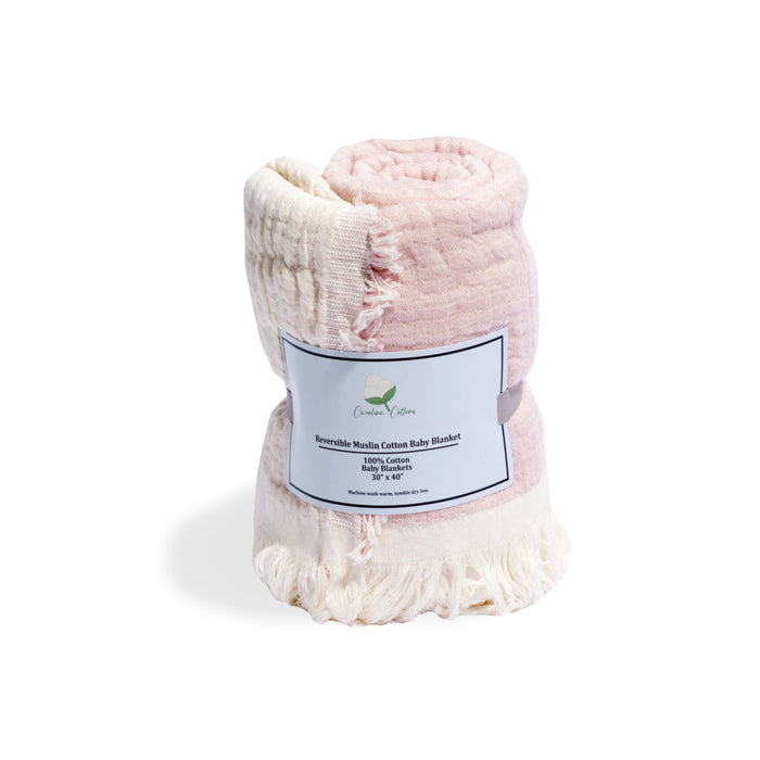 Pink baby blanket with a label on a white background