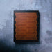 Wooden cutting board with a black border on a textured gray surface