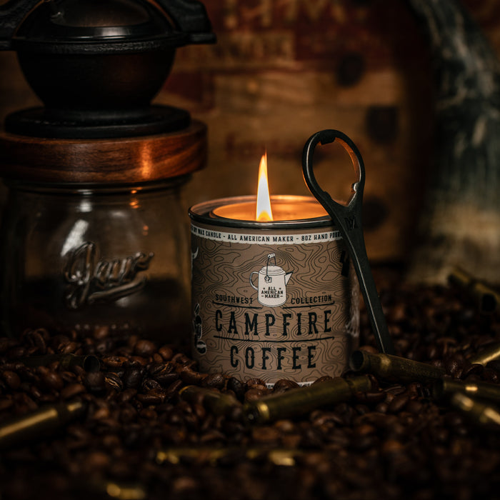 Campfire Coffee candle with a coffee grinder and coffee beans on a wooden background