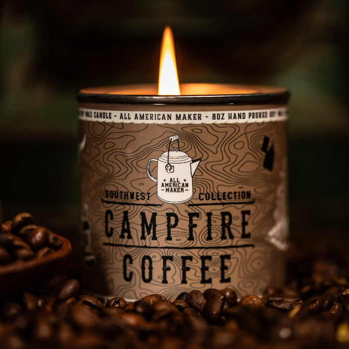 Candle labeled 'Campfire Coffee' surrounded by coffee beans with a blurred background