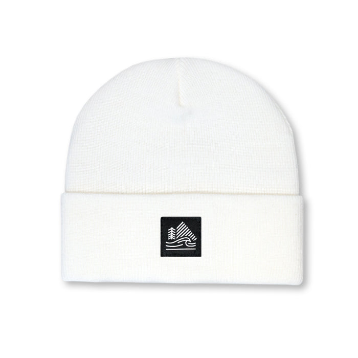 White beanie with a black logo patch on a white background