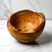 Wooden bowl on a marble surface