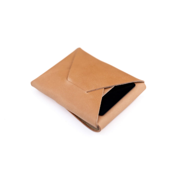 Tan leather pouch on a white background