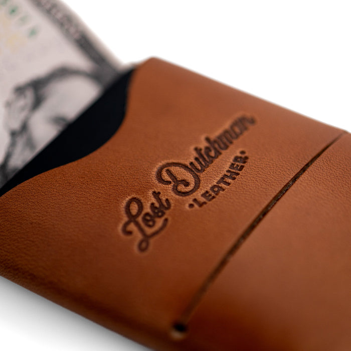 Brown leather wallet with 'Lost Dutchman Leather' branding on a white background