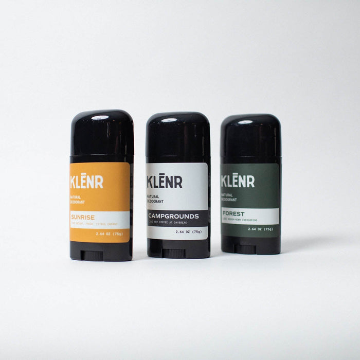Three deodorant sticks with different labels on a white background