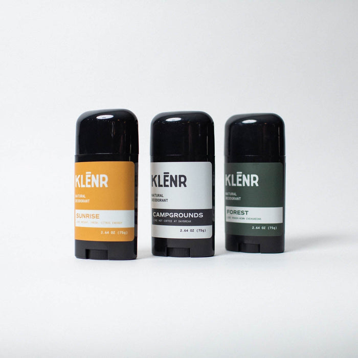 Three deodorant sticks with different labels on a white background