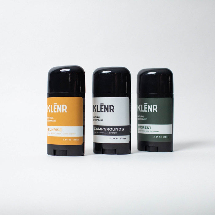 Three deodorant sticks with different labels on a white background