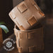 Brown leather product with 'Handmade in the USA' label on a blurred background