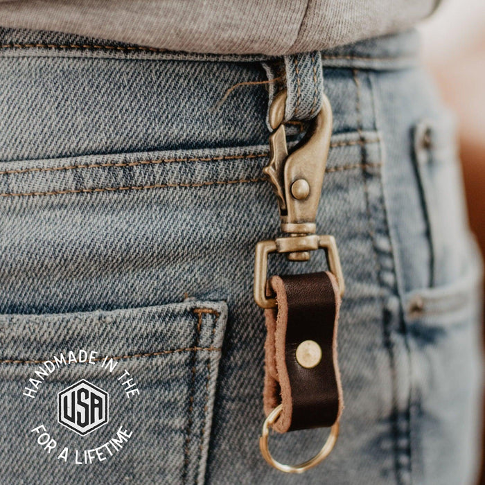 Leather keychain attached to a denim pocket with 'Handmade in the USA for a Lifetime' label.