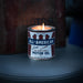 Candle in a container labeled 'All-American Pure Motor Oil' with a vintage feel.