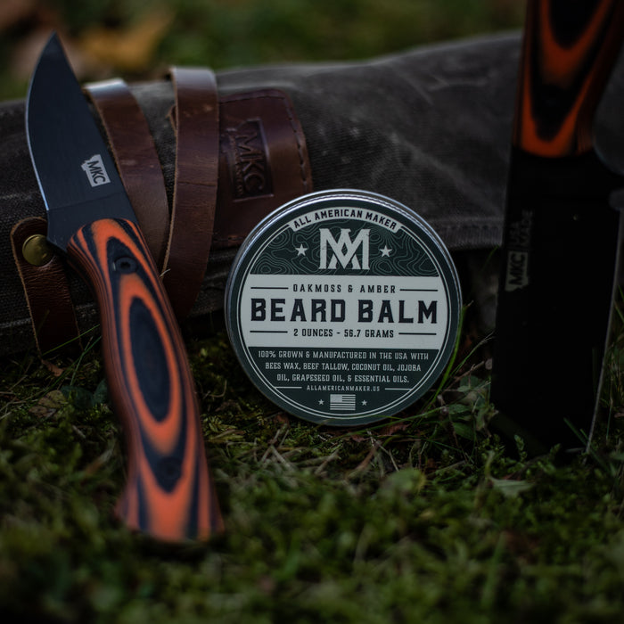 Beard balm container with a knife on grass