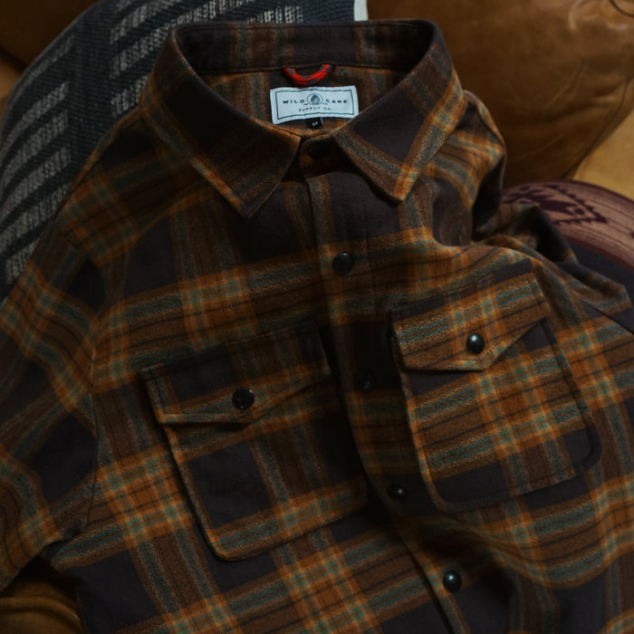 Plaid shirt with a brand label on a brown leather couch