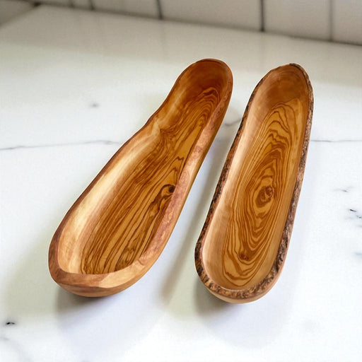 Two wooden bowls on a white marble surface