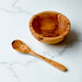 Wooden bowl and spoon on a marble surface