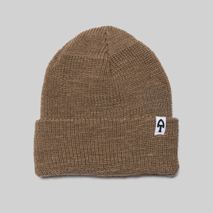 Brown knit beanie with a logo on a gray background