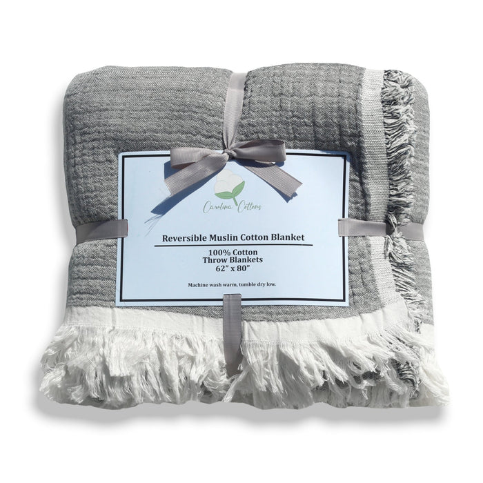Gray and white reversible muslin cotton blanket with a label on a white background