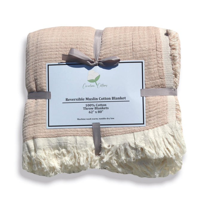 Reversible muslin cotton blanket with a label on a white background
