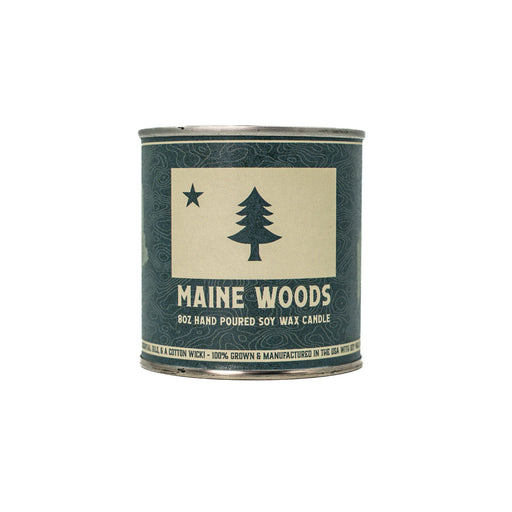 Candle container labeled 'Maine Woods' with a tree design on a white background