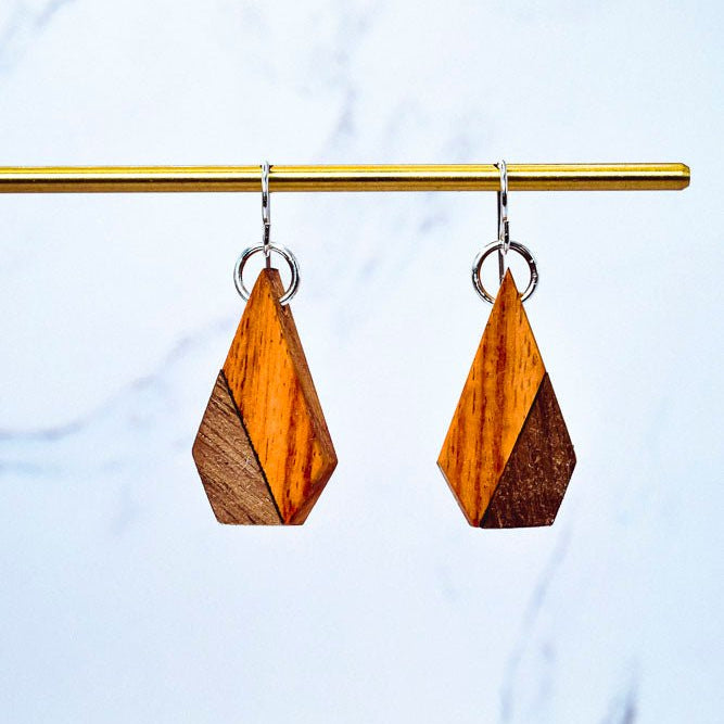 Wooden earrings with geometric design on a marble background