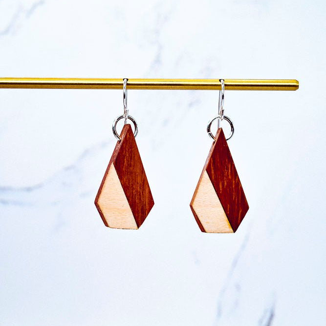 Wooden geometric earrings on a marble background