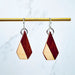 Wooden earrings with geometric design on a marble background