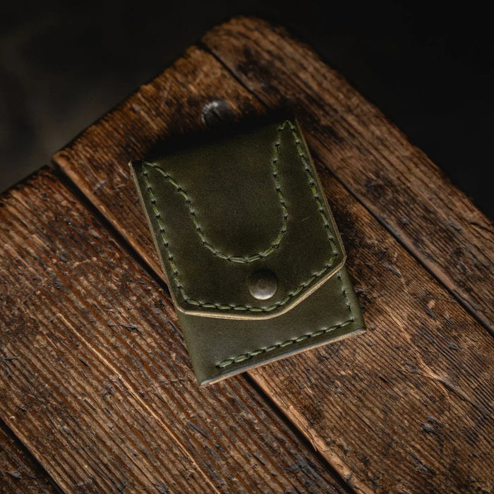 Green leather wallet on a wooden surface