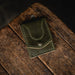 Green leather wallet on a wooden surface