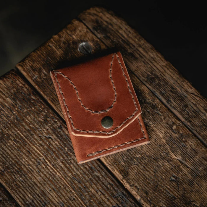 Brown leather wallet on a wooden surface