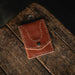 Brown leather wallet on a wooden surface