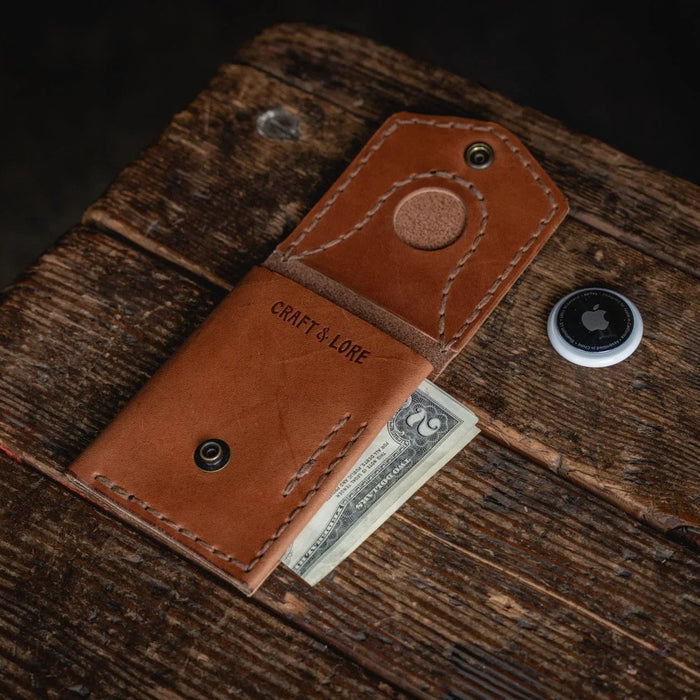 Brown leather wallet with money on a wooden surface