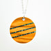 Wooden pendant with a striped pattern on a white background