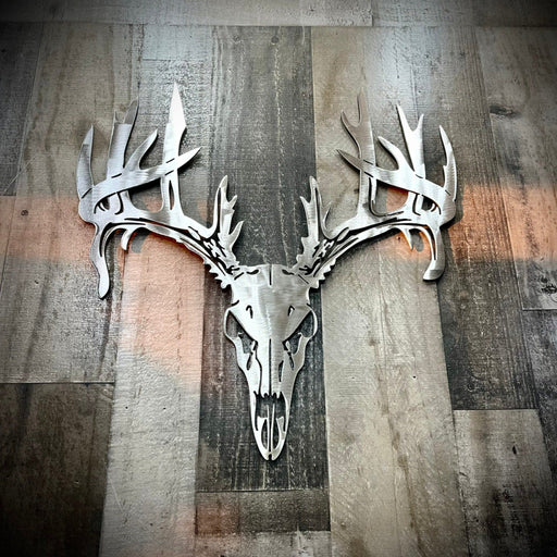 Metallic deer skull and antlers on a wooden wall
